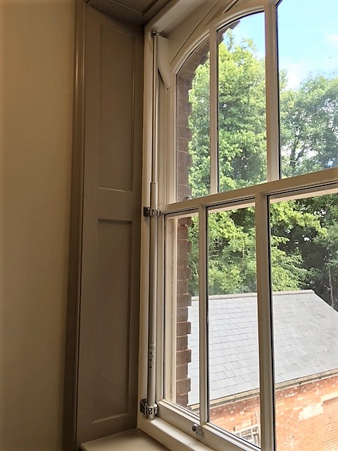 Surface mounted linear actuators on sliding sash window